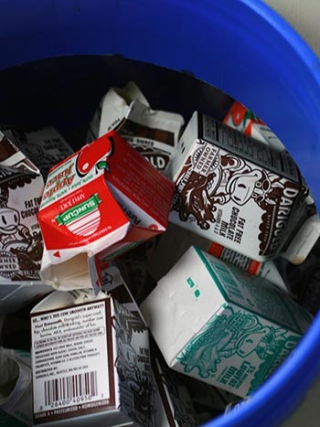 Milk cartons in a sort table bin